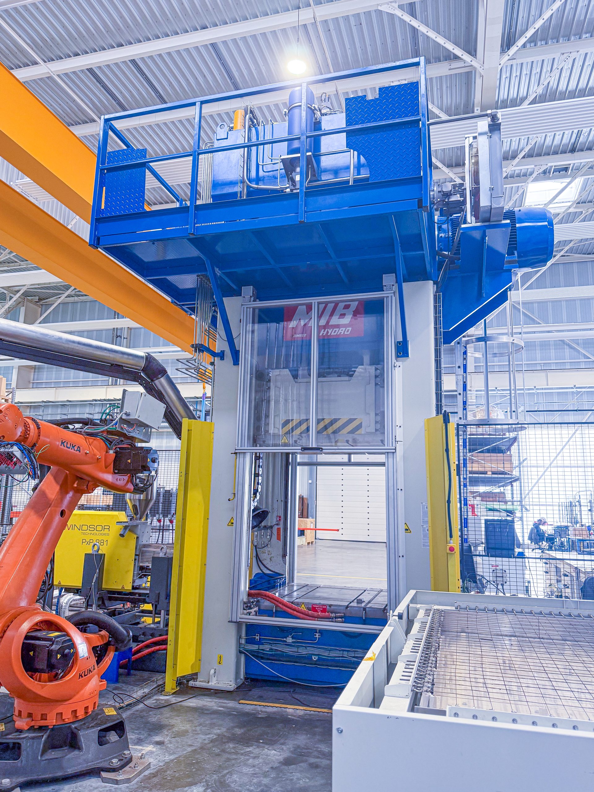 200-metric-tonne robotic vertical press cell coupled with an injection unit and an IR oven